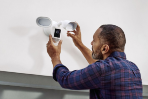 A person installing security system at home